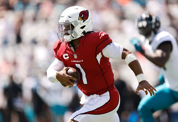 Kyler Murray models the Cardinals' red uniform tops. 