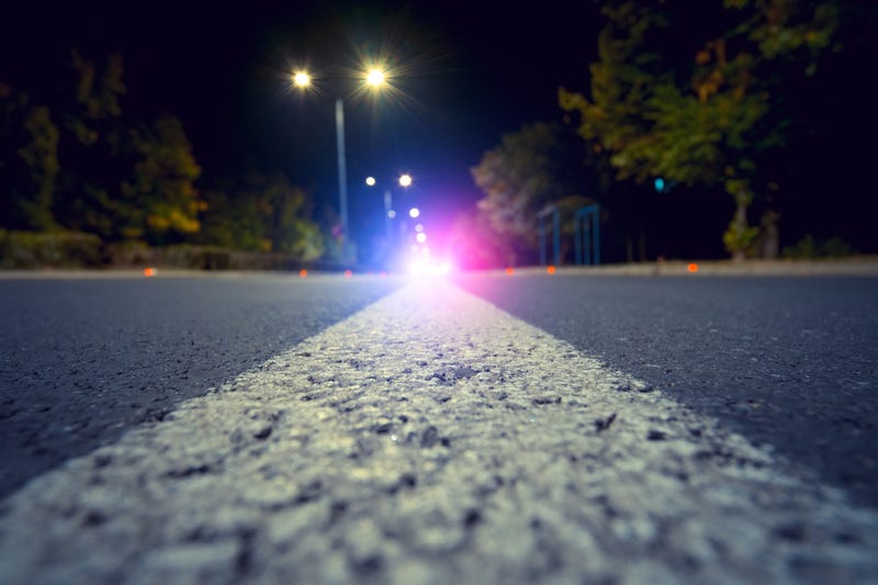 Police lights down the road. 