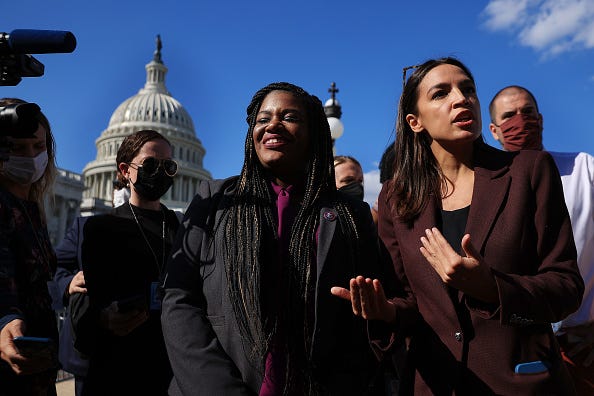 Rep. Cori Bush (D-GA) and Rep. Alexandria Ocasio-Cortez (D-NY) talk to reporters on Sept. 30, 2021.