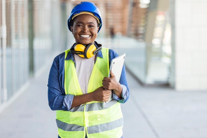 Portrait of woman at building site looking at camera with copy space.