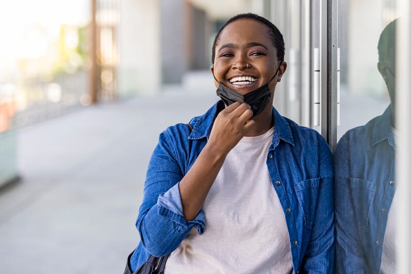 Black woman wearing disposable medical face mask