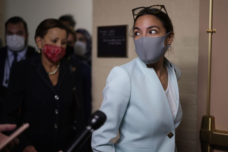 U.S. Rep. Alexandria Ocasio-Cortez (D-NY) (R) leaves after a House Democratic Caucus meeting with President Joe Biden at the U.S. Capitol October 1, 2021 in Washington, DC. President Biden called the meeting in order to push through an impasse with his $1 trillion infrastructure plan. 