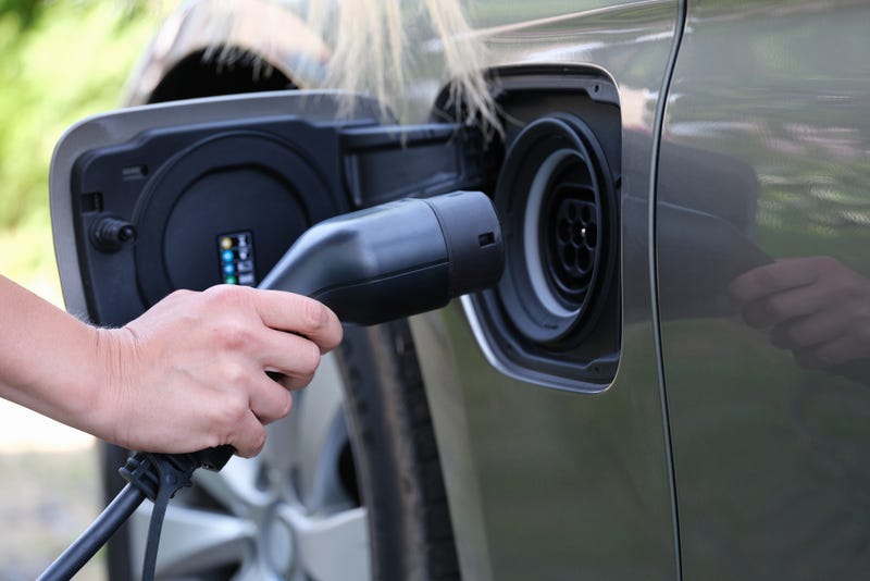 Person charging their electric vehicle. 