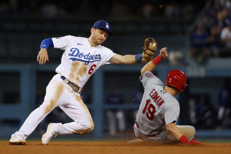 Tommy Edman #19 of the St. Louis Cardinals steals second against Trea Turner #6 of the Los Angeles Dodgers in the ninth inning.