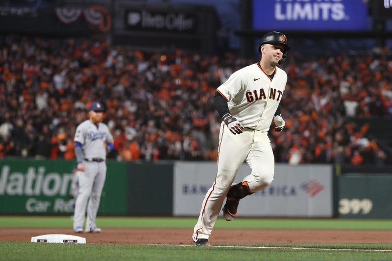 Buster Posey #28 of the San Francisco Giants rounds the bases after hitting a two-run home run off Walker Buehler #21 of the Los Angeles Dodgers during the first inning of Game 1 of the National League Division Series at Oracle Park on October 08, 2021 in San Francisco, California.