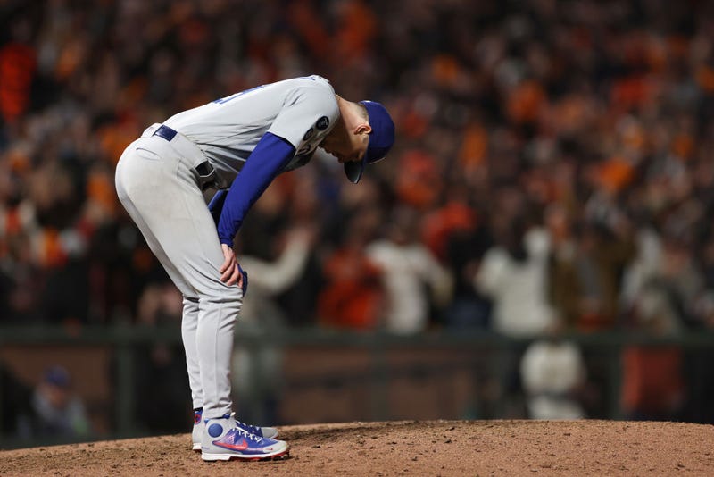 Walker Buehler #21 of the Dodgers reacts after allowing a solo home run to Kris Bryant #23 of the San Francisco Giants during the 7th inning of Game 1 of the NLDS.