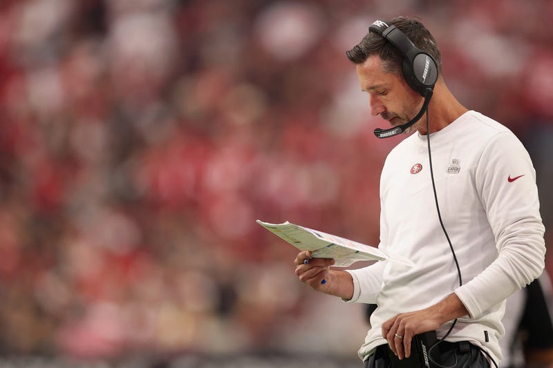 Head coach Kyle Shanahan of the San Francisco 49ers reviews his play card during the second half of the NFL game against the Arizona Cardinals at State Farm Stadium on October 10, 2021 in Glendale, Arizona.