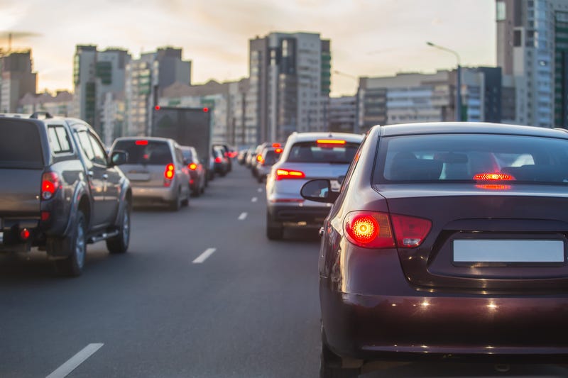 Back of cars driving on road