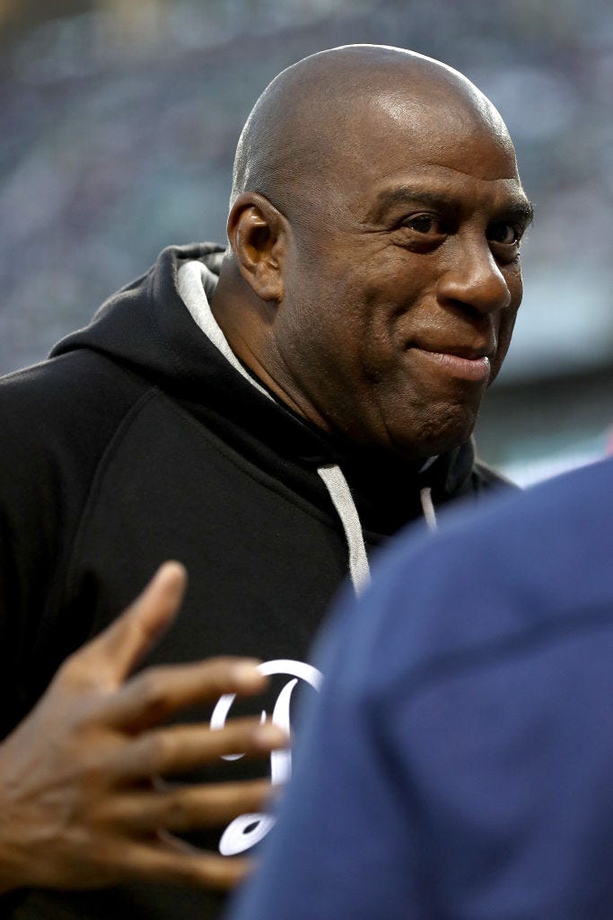 Magic Johnson looks on before game 4 of the National League Division Series.