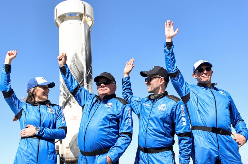Blue Origin vice president of mission and flight operations Audrey Powers, Star Trek actor William Shatner, Planet Labs co-founder Chris Boshuizen and Medidata Solutions co-founder Glen de Vries wave during a media availability on the landing pad of Blue Origin’s New Shepard after they flew into space on October 13, 2021 near Van Horn, Texas. Shatner became the oldest person to fly into space on the ten minute flight. They flew aboard mission NS-18, the second human spaceflight for the company which is owned by Amazon founder Jeff Bezos. (Photo by Mario Tama/Getty Images)