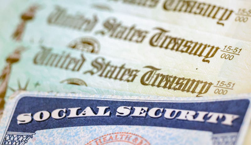 In this photo illustration, a Social Security card sits alongside checks from the U.S. Treasury on October 14, 2021 in Washington, DC.