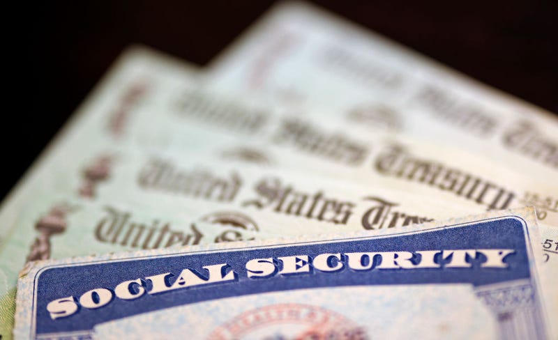  In this photo illustration, a Social Security card sits alongside checks from the U.S. Treasury on October 14, 2021 in Washington, DC.