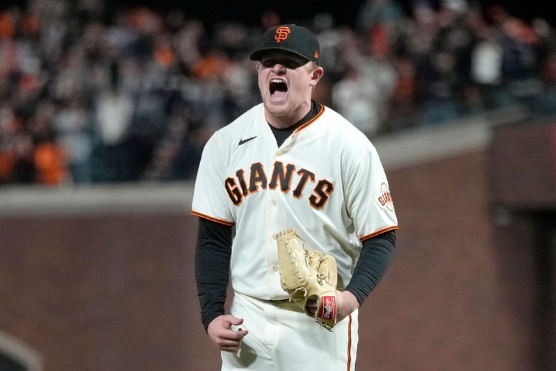 Logan Webb #62 of the San Francisco Giants reacts after striking out Cody Bellinger #35 of the Los Angeles Dodgers at the top of the seventh inning in game 5 of the National League Division Series at Oracle Park on October 14, 2021 in San Francisco, California.