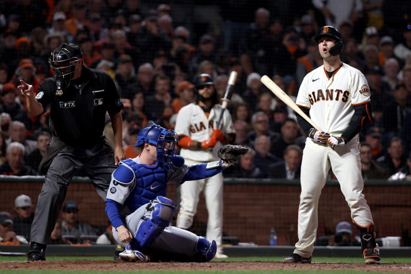 Buster Posey #28 of the San Francisco Giants reacts after a strike during the eighth inning in game 5 of the National League Division Series against the Los Angeles Dodgers at Oracle Park on October 14, 2021 in San Francisco, California.