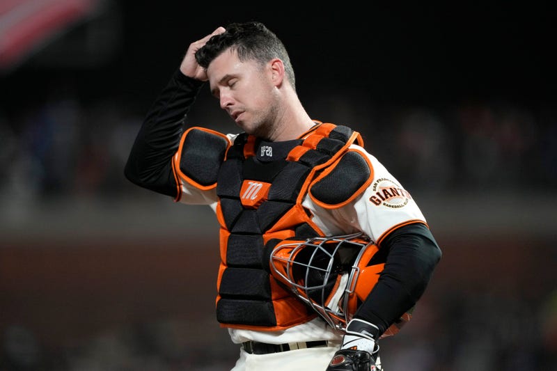 Buster Posey #28 of the San Francisco Giants reacts after a single by Gavin Lux #9 of the Los Angeles Dodgers during the ninth inning in game 5 of the National League Division Series at Oracle Park on October 14, 2021 in San Francisco, California.