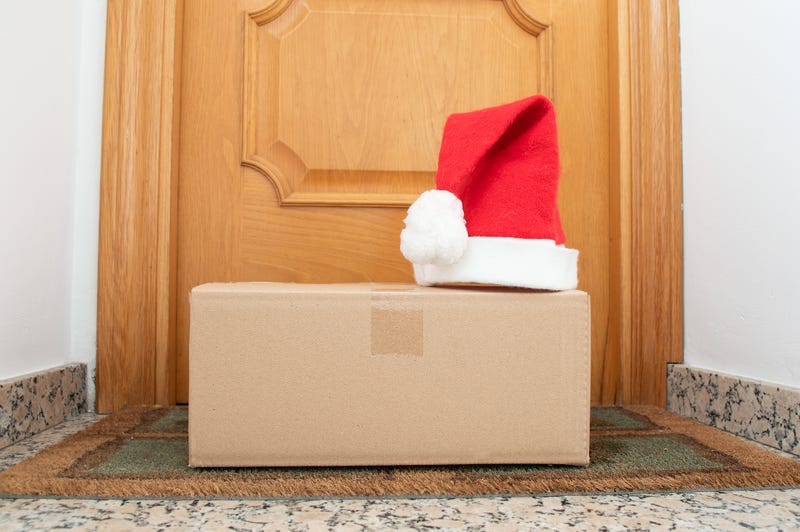 Santa hat on cardboard box in front of door