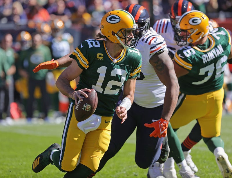 Aaron Rodgers #12 of the Green Bay Packers is chased by Akiem Hicks #96 of the Chicago Bears at Soldier Field on October 17, 2021 in Chicago, Illinois. The Packers defeated the Bears 24-14.