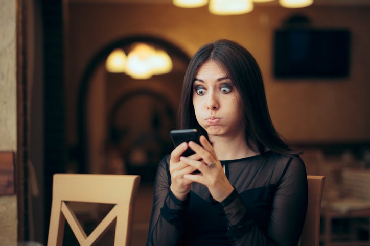 Embarrassed woman on the phone