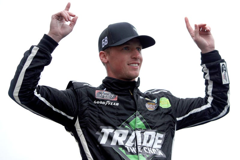 Brandon Brown, driver of the #68 TradeTheChain.com Chevrolet, waves to fans during pre-race ceremonies prior to the NASCAR Xfinity Series Kansas Lottery 300 at Kansas Speedway on October 23, 2021 in Kansas City, Kansas. (Photo by Sean Gardner/Getty Images)