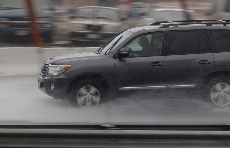  A car drives through flooded a section of Highway 101 on October 24, 2021 in Corte Madera, California.