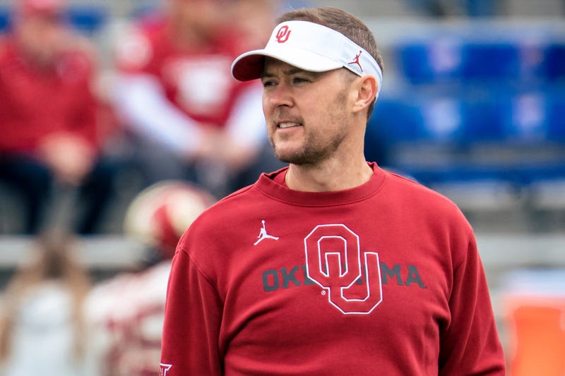 Head coach Lincoln Riley of the Oklahoma Sooners talks to players during warmups before taking on the Kansas Jayhawks at David Booth Kansas Memorial Stadium on October 23, 2021 in Lawrence, Kansas. 
