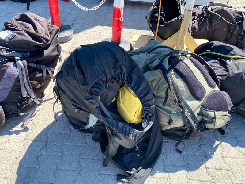 Parachute backpacks for extreme skydiving lie on the ground.