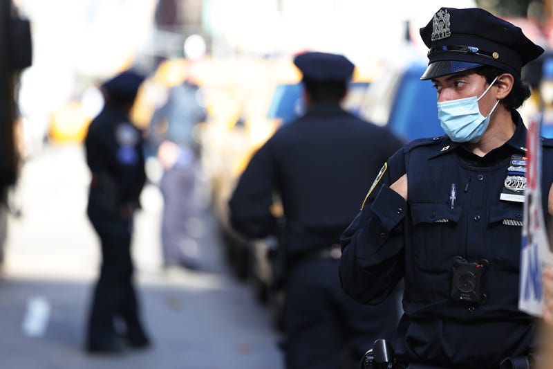 NYPD officers stand guard as people gather to protest vaccine mandates for city workers at City Hall Park on November 03, 2021 in New York City. Protestors gathered at City Hall Park to protest the mandatory unpaid leave for city workers for refusing Mayor Bill de Blasio's coronavirus (COVID-19) vaccine mandate. The group also protested New York City Mayor-elect Eric Adams "flip-flop" on vaccine mandates for workers and students.