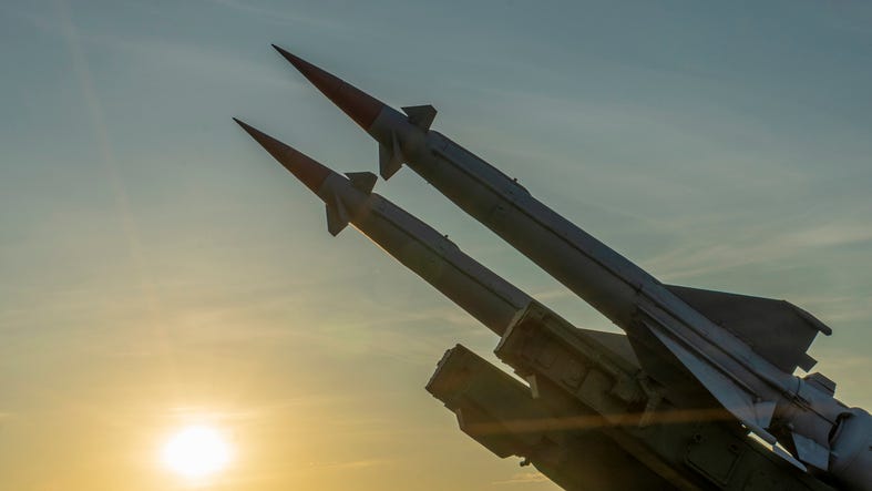 Two combat missiles aimed at the sky.