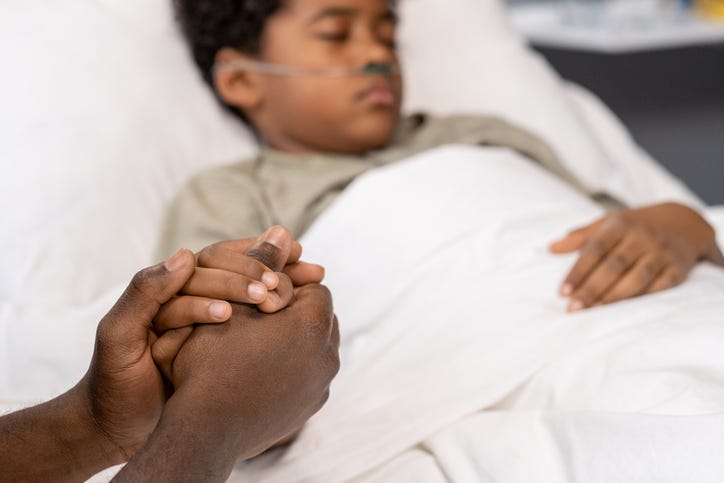 Father supporting his sick son