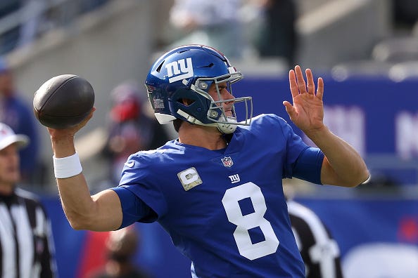 Daniel Jones models the Giants' blue uniform tops. 