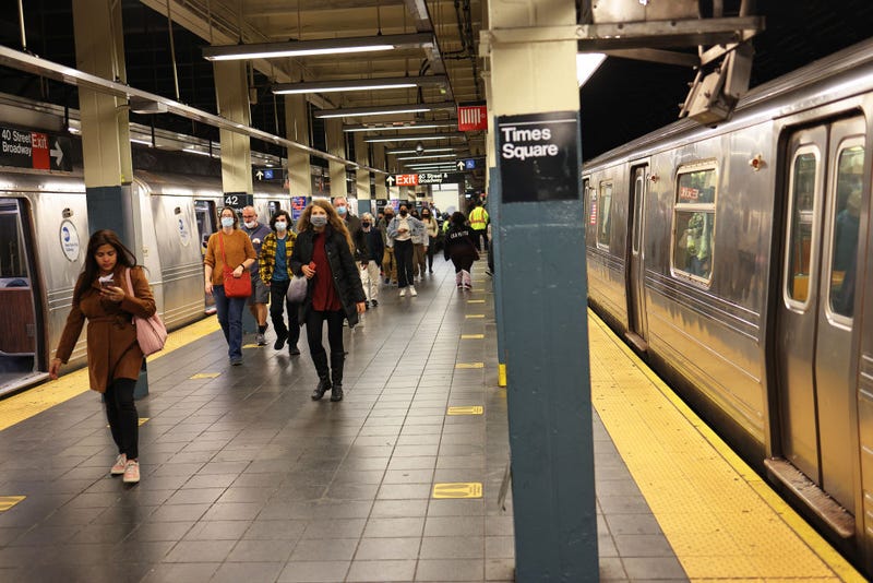 People walk along the train platform at the 42nd Street subway station on November 09, 2021 in New York City.