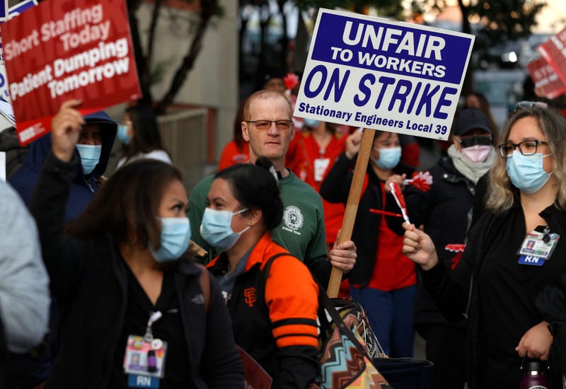 Kaiser Permanente union worker holds an on strike sign as Kaiser Permanente nurses and workers stage an informational picket outside of the Kaiser Permanente San Francisco Medical Center on November 10, 2021 in San Francisco, California.