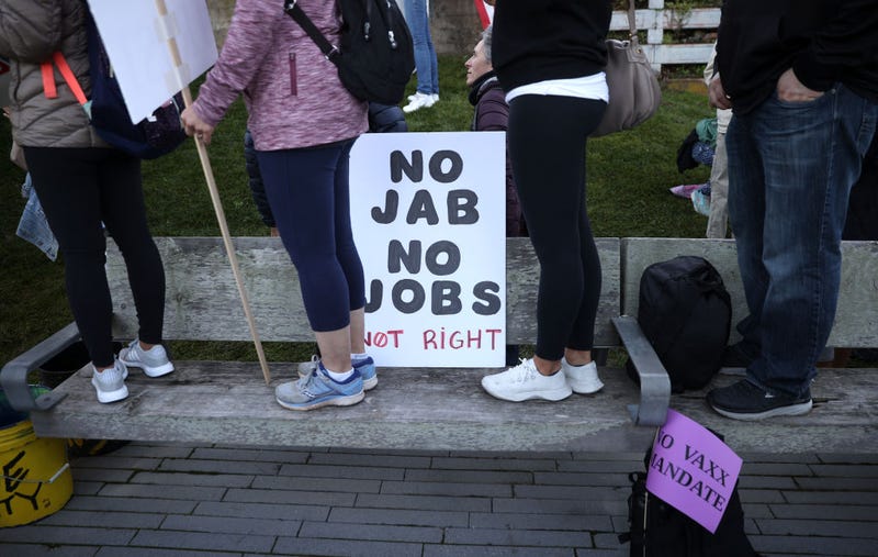 Protesters stand next to a sign during an anti-vaccination rally at the Golden Gate Bridge on November 11, 2021 in San Francisco, California. Protesters against the COVID-19 vaccination gathered at the Golden Gate Bridge to rally against vaccine mandates. (Photo by Justin Sullivan/Getty Images)