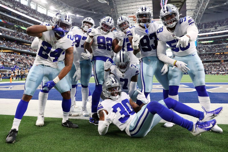 The Dallas Cowboys celebrate an interception by Trevon Diggs #7 of the Dallas Cowboys against the Atlanta Falcons during the third quarter at AT&T Stadium on November 14, 2021 in Arlington, Texas.