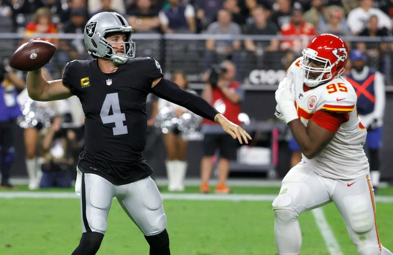 Quarterback Derek Carr #4 of the Las Vegas Raiders throws under pressure from defensive end Chris Jones #95 of the Kansas City Chiefs during their game at Allegiant Stadium on November 14, 2021