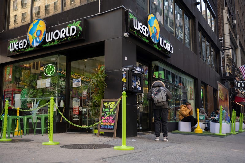 People sit in a "smoking section" outside Weed World on Nov. 16, 2021, in Midtown Manhattan