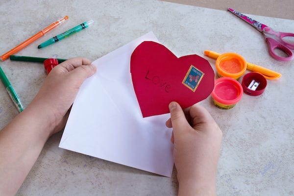 Kid holding a homemade Valentine