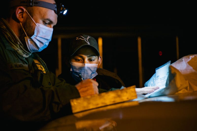 A border patrol officer begins processing a young boy after he crossed the Rio Grande into the U.S. on November 17, 2021 in La Joya, Texas. 