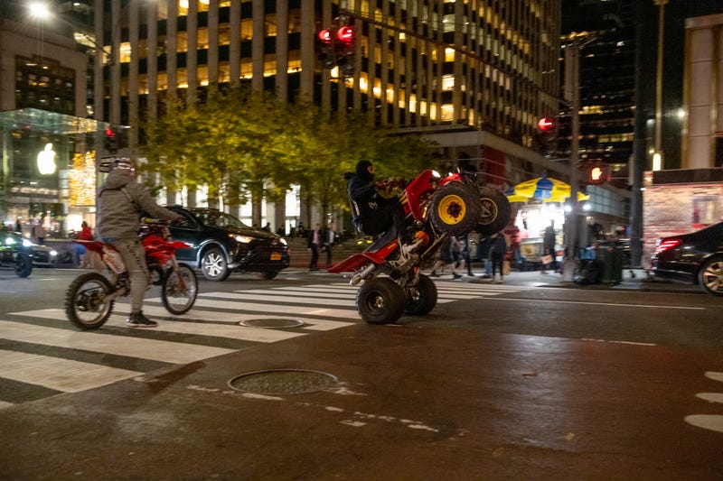 People ride dirt bikes and ATVs down Fifth Avenue in New York City