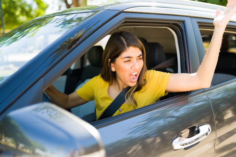 Upset woman stuck in traffic yelling