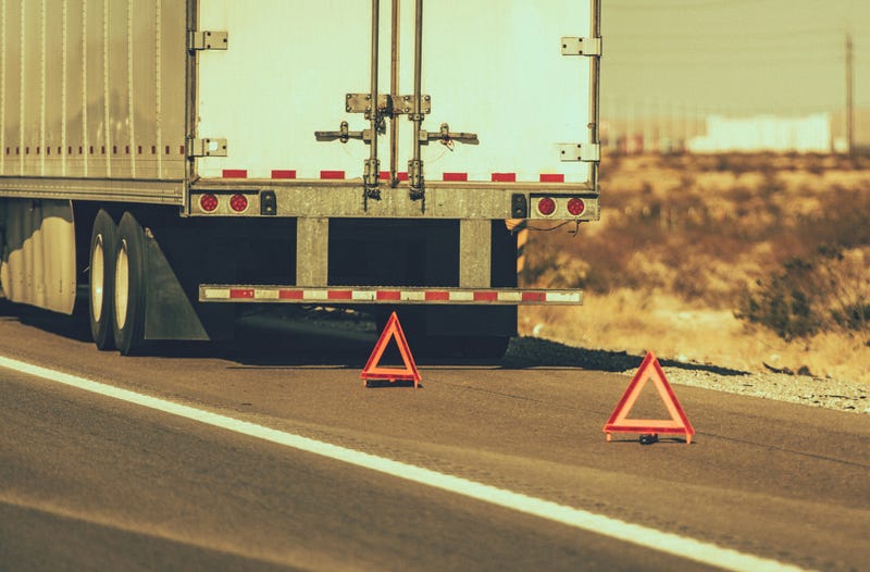 Warning lights out in front of a semi.