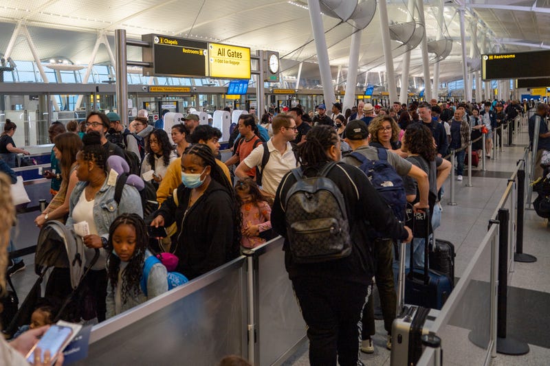 People wait in line at the security checkin of JFK International airport on June 30, 2023 in New York City. 