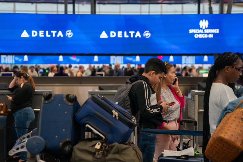People wait in line at the Delta Airlines checkin counter of JFK International airport on June 30, 2023 in New York City.