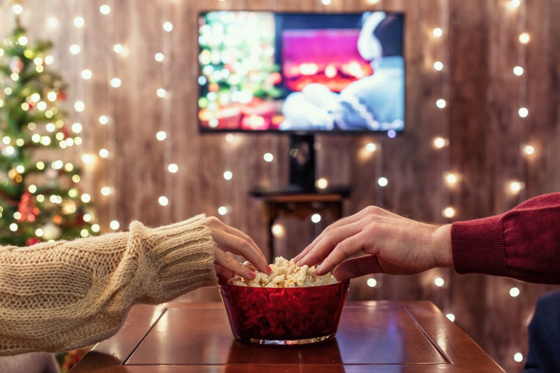 Watching holiday movie sharing popcorn