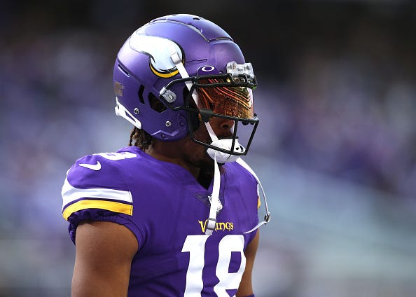 Justin Jefferson models the Vikings purple uniform tops. 