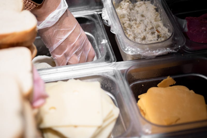 Behind the counter of a sandwich shop. 