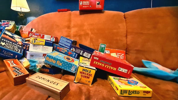 Collection of board games on a couch