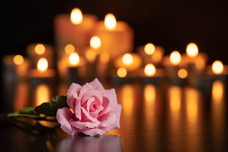 Flower and candles burning for someone who passed away. 