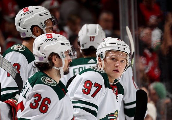 Kirill Kaprizov #97 of the Minnesota Wild looks on from the bench against the New Jersey Devils at Prudential Center on November 24, 2021 in Newark, New Jersey.