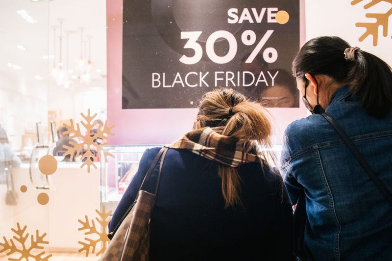 Shoppers view merchandise through a store window during Black Friday in The Galleria mall on November 26, 2021 in Houston, Texas. 